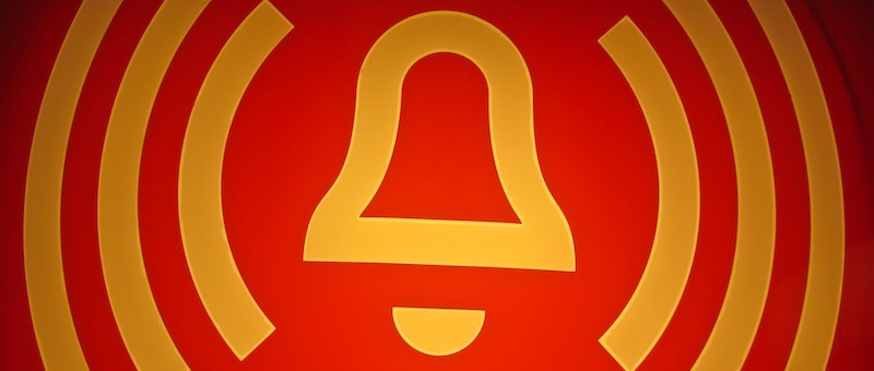 danger bell in yellow on red background